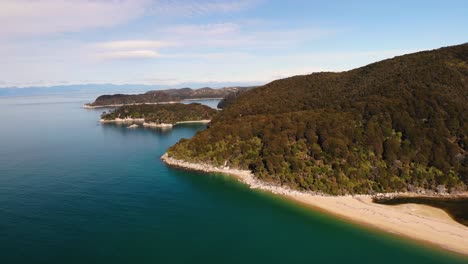 shape of abel tasman coast aerial orbit shot reveal of the small bay and sandy beach in contrast to jungle forrest