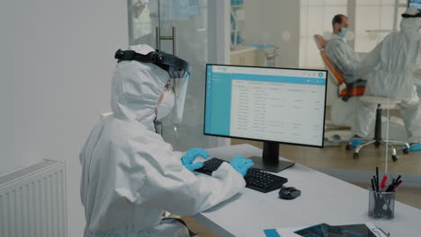 enfermera de estomatología sentada en un escritorio usando una computadora moderna