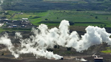 smoke spreading in the environment from the geothermal power plant, aerial shot