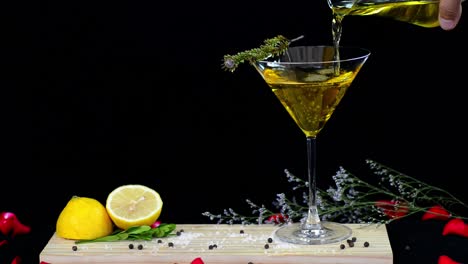 Bar-keeper-pouring-sweet-liquor-served-on-wooden-tablet-with-fresh-citron-deco