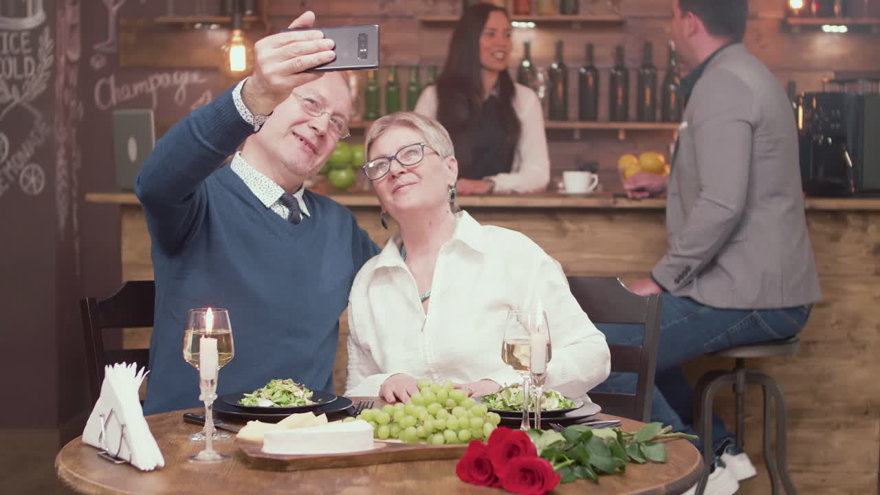 Couple taking a selfie during a date night at a restaurant