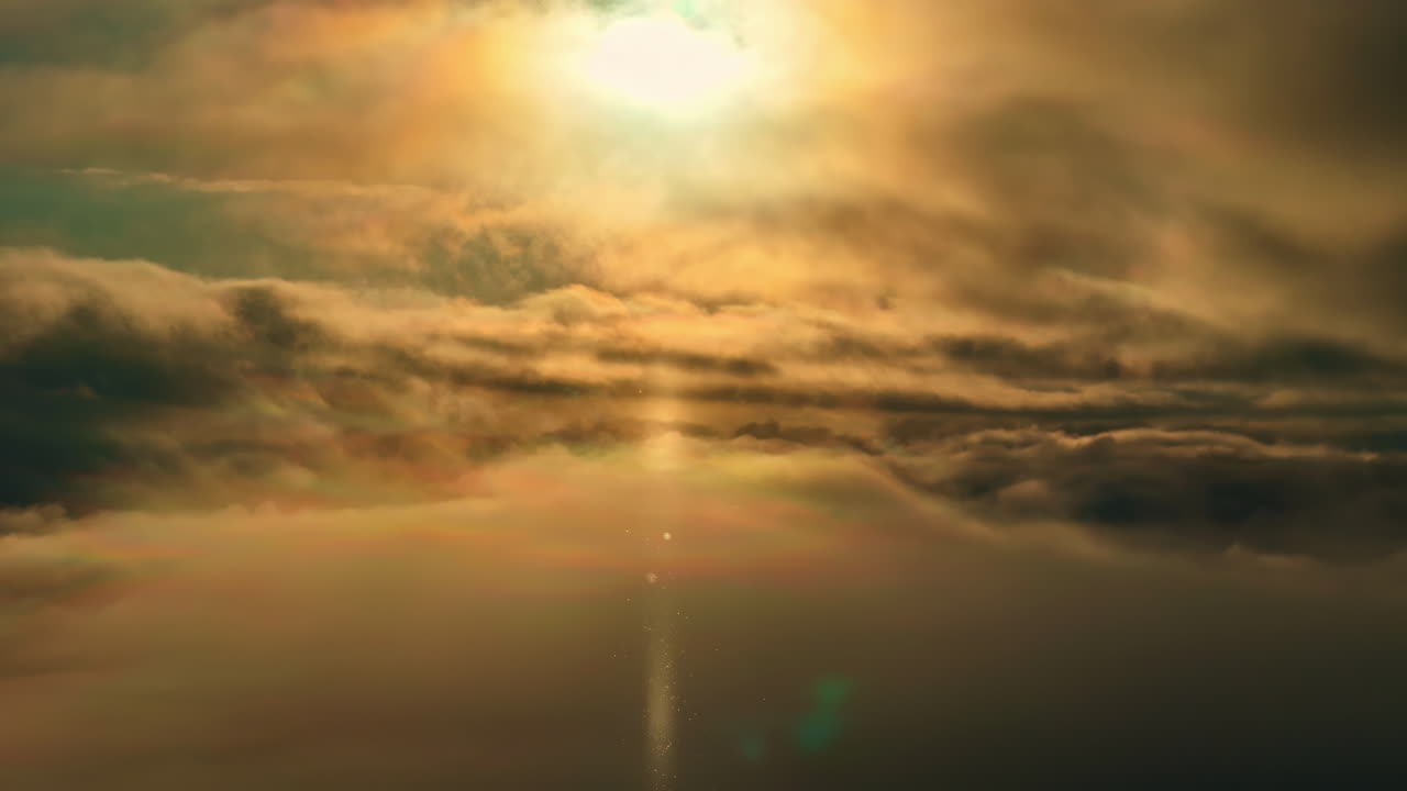 Dramatic aerial view amidst dark clouds with an orange sun shining on it