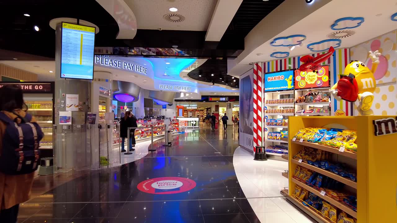 POV passenger walking through beautiful duty-free shops of Brussels Zaventem Airport, Belgium