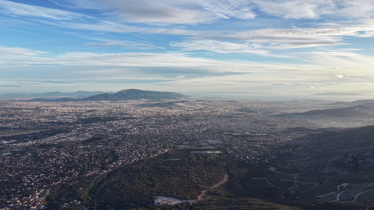 Captured in February from 1200m above Regency Casino Mont Parnes on Mount Parnitha, this drone footage reveals Athens' vast urban expanse below. Slowly retreating backward,
