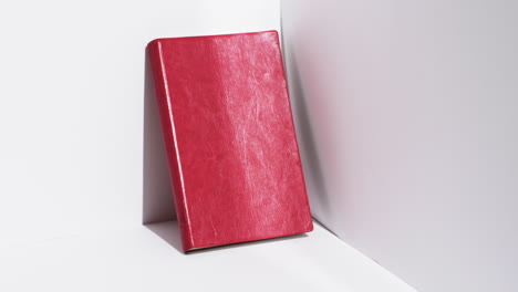 video of book in red cover and copy space on white background