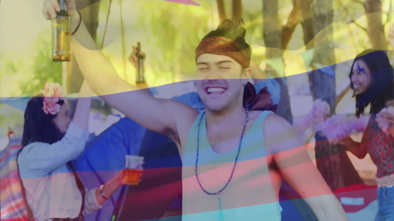 People celebrating outdoors with drinks over animation of waving colombia flag