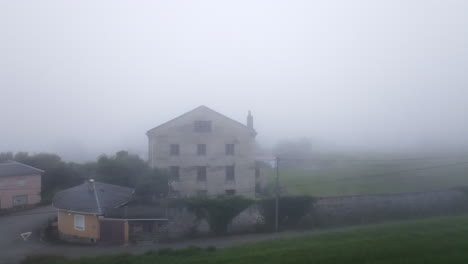 foggy rural village scene with old house