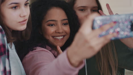 multiracial teenage girls taking photo using smartphone posing making faces enjoying hanging out together sharing friendship on social media