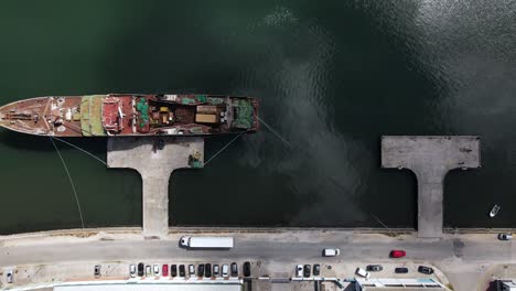 top down aerial view of an industrial harbour with a cargo ship in a dock