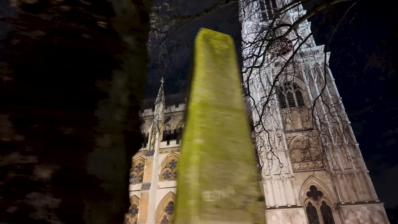 First-person nighttime contemplative shot of Westminster Abbey during a walk along Broad Sanctuary in London, United Kingdom