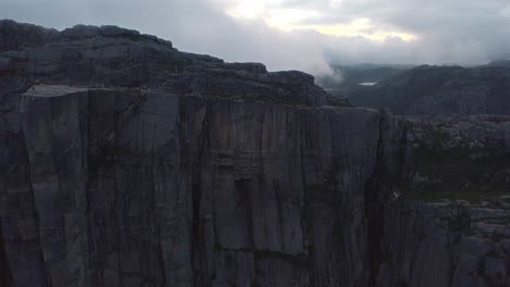 massive rock formations in norway's dramatic mountainous landscape with misty weather
