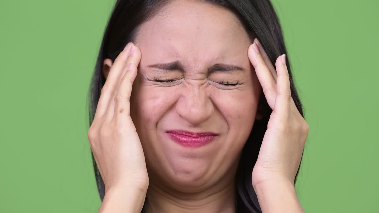 Young beautiful Asian businesswoman having headache