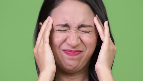 young beautiful asian businesswoman having headache