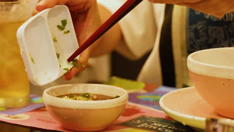 adding ingredients to a sauce bowl