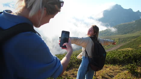 two friends hiking in the mountains taking a selfie