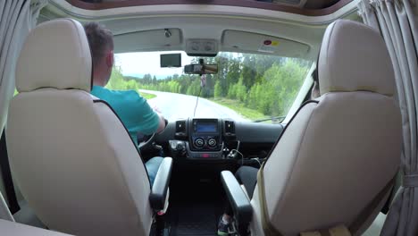 man driving on a road in the camper van rv