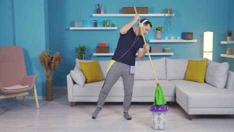 a man cleaning while listening to music with headphones.