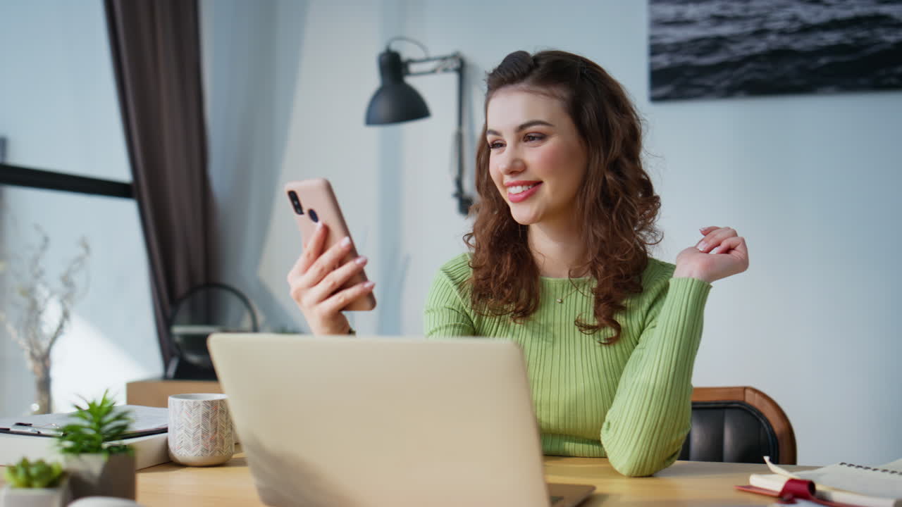 Relaxed lady tapping cellphone at light office closeup. Businesswoman laughing