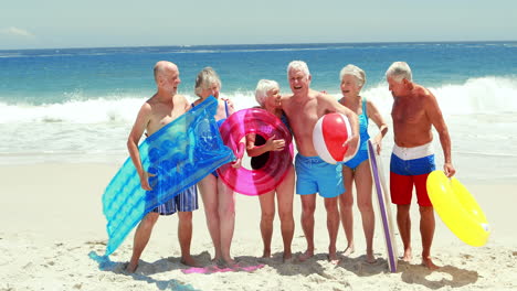 Happy-senior-friends-holding-inflatables