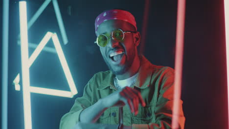 stylish man posing under neon lights