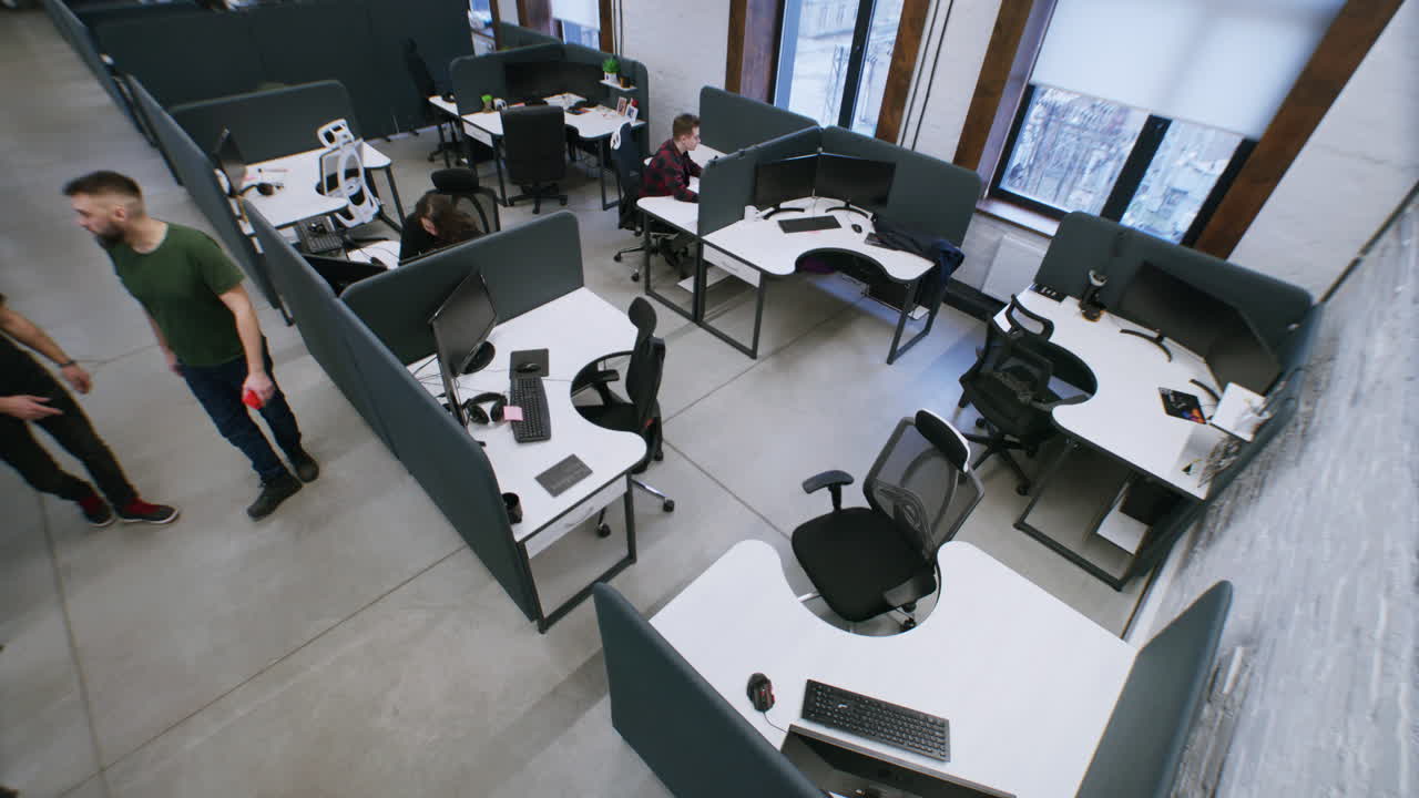 High-angle view of a modern open-plan office space with employees working at workstations