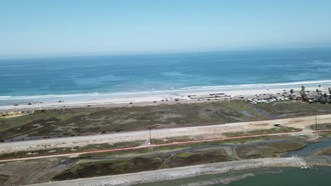 aerial view from a drone flying parallel to the coast over land showing the sea