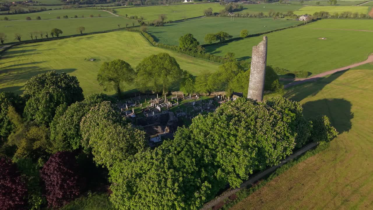 Graveyard And Round Tower At Monasterboice Ruins In County Louth, Ireland. - aerial shot