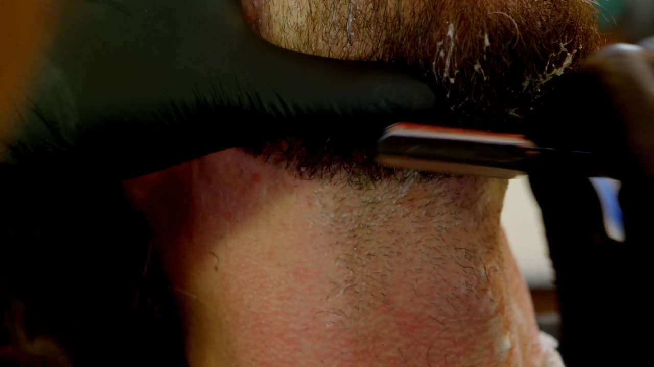 peluquero usando una maquinilla de afeitar en el salón de belleza 4k