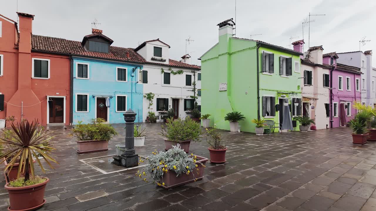 Colourful Painted residential house facades Burano. Establishing pan shot