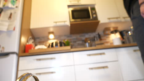 view inside dishwasher, door opens and man lifts out basket with dishes then closes door