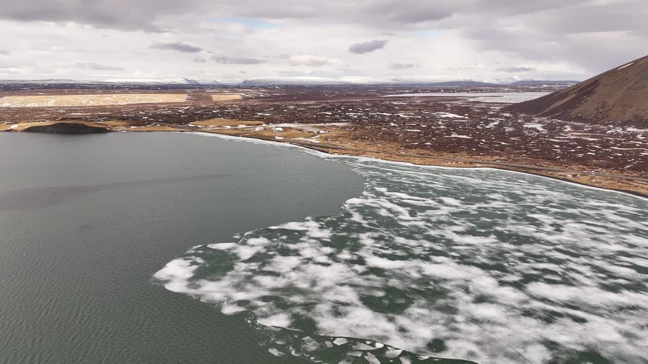 Aerial view of breaking lake ice near Skútustaðir and Reykjahlíð during early summer thaw. Mývatn, Iceland