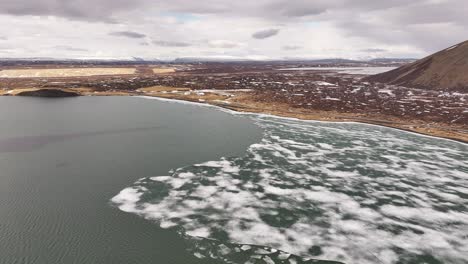 aerial view of breaking lake ice near skútustaðir and reykjahlíð during early summer thaw. mývatn, iceland