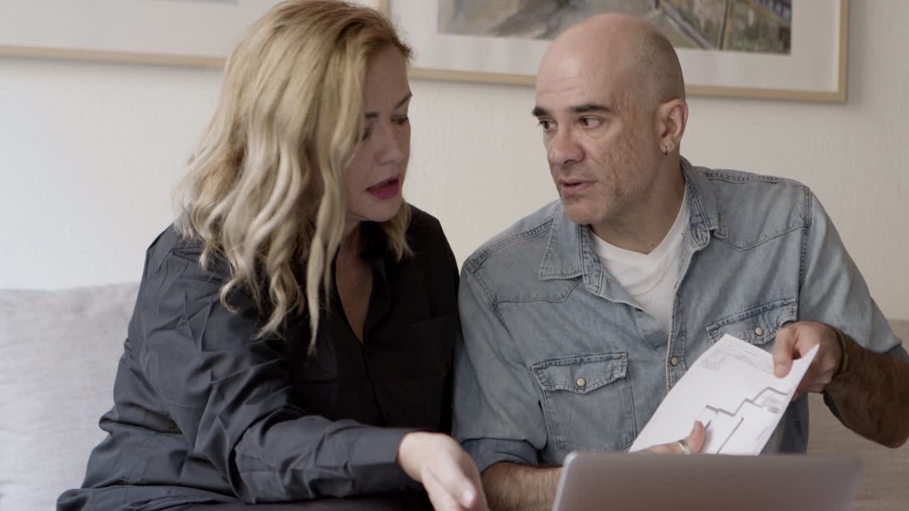 Front view of serious couple looking at home project