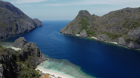 aerial shot of isolated islands in stunning blue sea