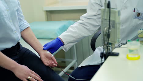 Doctor examining of female patient. Portrait of young doctor examining patient