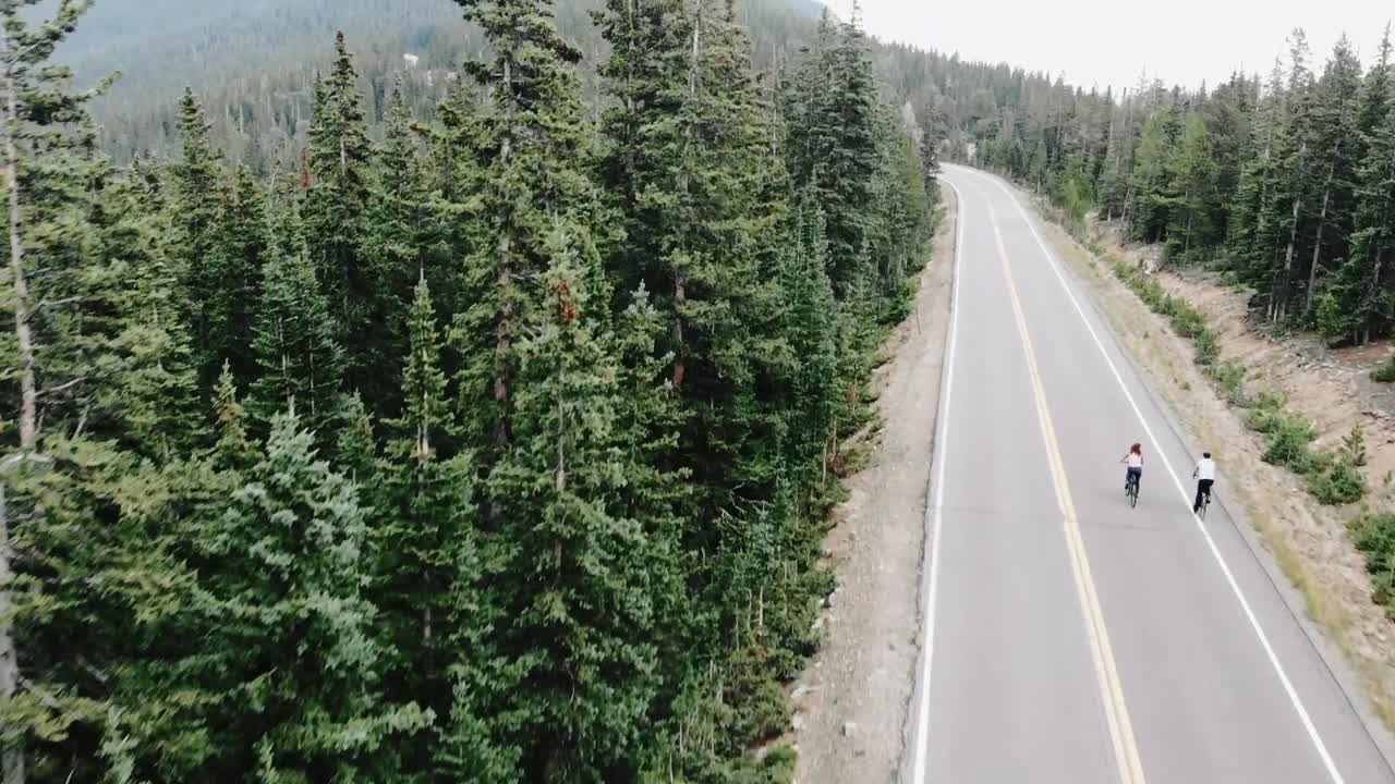Tilt-up reveal of two cyclists near Evergreen Colorado, USA.
