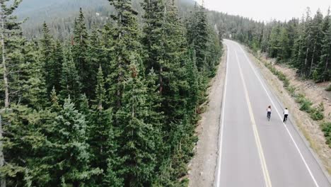 tilt-up reveal of two cyclists near evergreen colorado, usa.