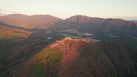 Aerial-Drone-Rotates-Above-Japanese-Mountain-Range-in-Hyogo-Asago-Landscape-Sky-is-Clear-around-Takeda-Castle-Ruins