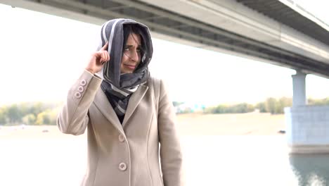 middle eastern girl twists his finger at her temple