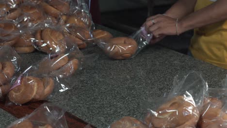 packing of bread and and labelling them in a plastic bag in bakery