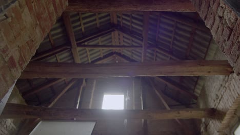 the interior of an empty abandoned brick barn