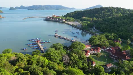 Drone-flight-at-a-beach-in-langkawi,-malaysia-drone-flies-at-a-hotel-complex-by-the-sea-with-a-view-of-the-sea-and-many-trees