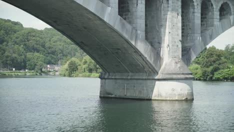 View-through-railway-bridge-Pont-du-Chemin-de-Fer-at-the-landscape,-Huy,-Hoei,-Ardennes,-Belgium,-Europe,-4K,-25fps