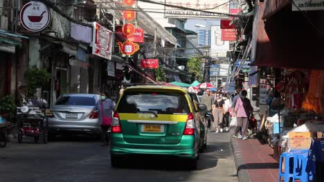 taxi driving through a busy urban street