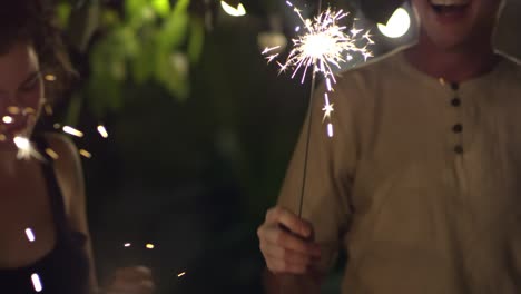 friends holding sparkler fireworks