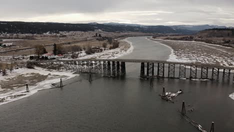 the wooden structure of the pritchard bridge in a majestic winter landscape