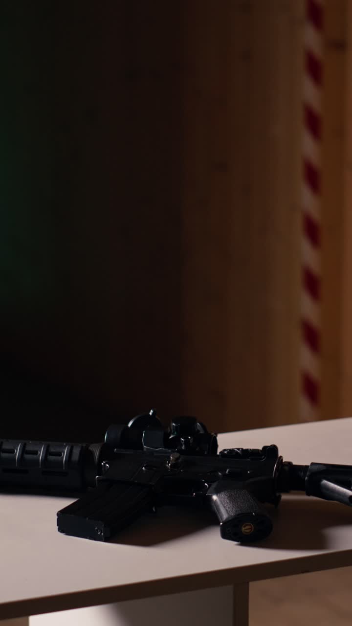 Vertical video Rifle and pistol at shooting range to be used in training, close up
