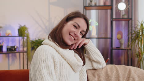 smiling woman sitting on a couch