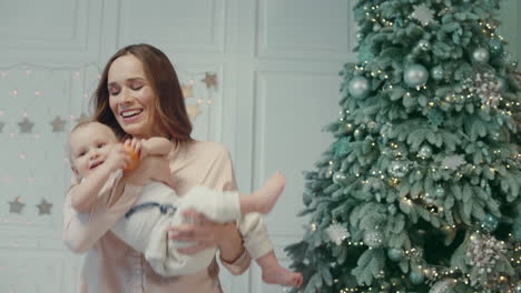 smiling young woman playing with baby boy in luxury apartment.