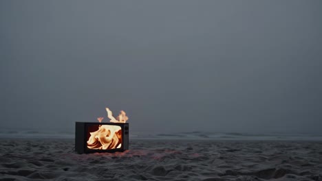 burning tv on the beach at dusk